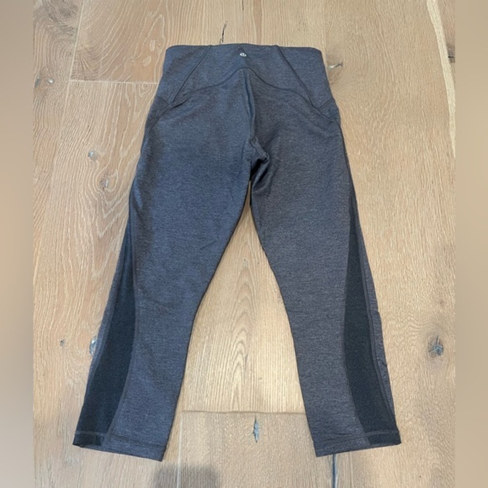 Lululemon Gray 3/4 length leggings with gray mesh on the calf area.  Size 8